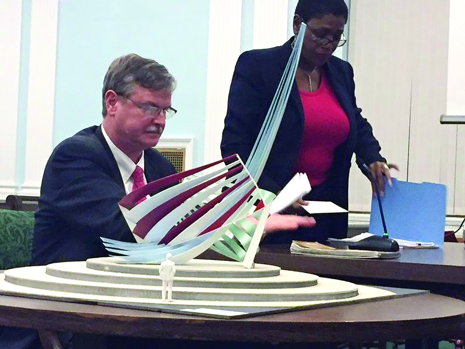 Mayor Paul Dyster is shown with a model of a sculpture he plans for a small traffic circle on Rainbow Blvd. The sculpture will cost taxpayers $472,000 of state, city and Greenway money.  Standing next to him is City Administrator Donna Owens who will be axed - but not until after she stays on past her eighth anniversary so she can pick up additional taxpayer funded goodies. 
One thing about Dyster: He is never transparent. He could have said, when announcing Owens’ departure date, that he wanted her to stay until she got one more year of benefits. But he didn’t. Sly.