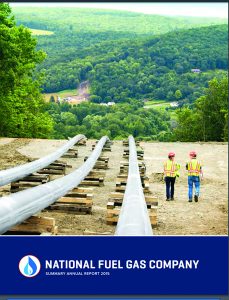 The cover of National Fuel Gas’ 2015 annual report shows a pipeline running directly into a scenic rural town and two helmeted workers walking along it for perspective.