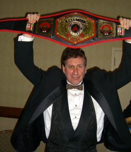 Frank Dux holding one of his many championship belts.