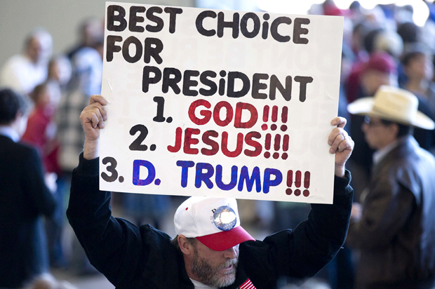 A supporter of Republican presidential candidate Donald Trump holds a sign before  a rally Saturday, Feb. 27, 2016, in Bentonville, Ark. (AP Photo/John Bazemore)