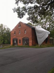 The tarp has been dangling off the DeVeaux Woods Carriage Barn for over three months. Hopefully State Parks will repair it so that future generations can enjoy this historic building (photo by Michael Federspiel).