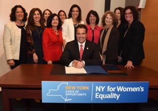 Gov. Andrew Cuomo signs a bill on Oct. 21, 2015 enhancing women's rights at the same time his administration was ignoring reports of women being branded by a cult leader.