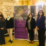 Pictured with the suffrage exhibit, from left to right are:  Niagara County Legislature Chairman Becky Wydysh, Legislator Irene Myers, Legislator Anita Mullane and Mary Brennan-Taylor.